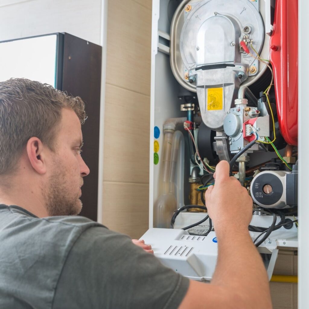 technician repairing a gas furnace